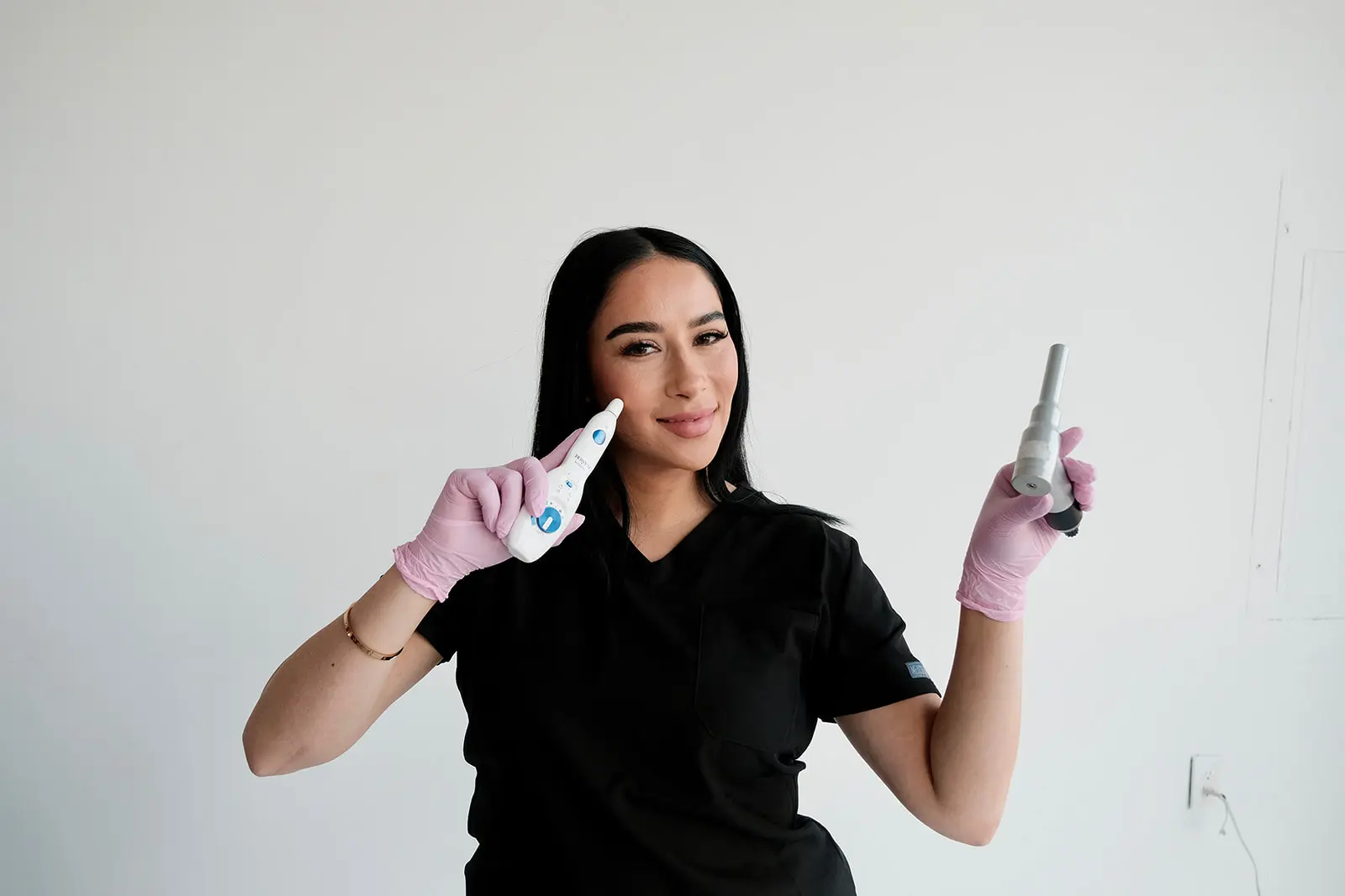 Woman holding dental tools, smiling