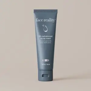 White background with a tube of face reality sulfur spot treatment, which is a cream-colored tube with text on it