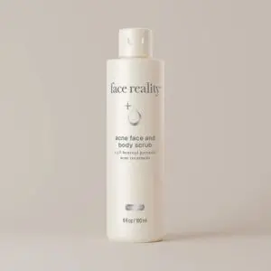 White bottle of face reality acne face and body scrub with a cap