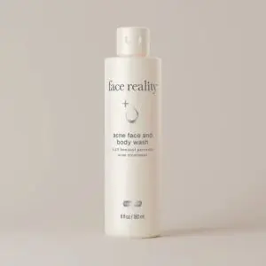White bottle of face reality acne face and body wash with a cap