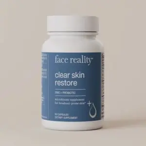 White bottle with the words "face reality clear skin restore" printed on it, set against a white background