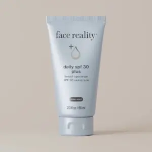 White background with a tube of Face Reality Daily SPF 30 Plus Broad Spectrum SPF 50+ Sunscreen